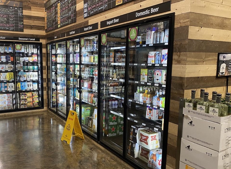 Glass doors of a walk-in beer cooler in a store