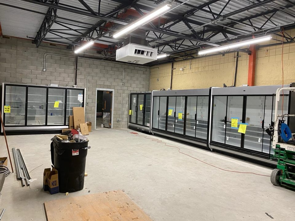Long line of glass door coolers installed in a new store