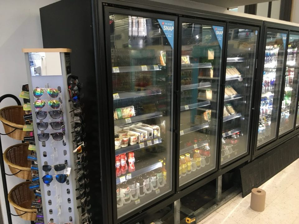 Glass door freezers stocked with product in a store