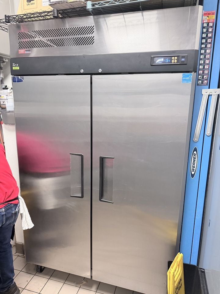 Two-door stainless steel reach-in freezer in a restaurant kitchen