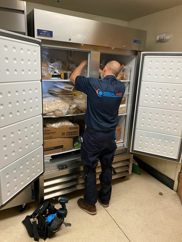 Cool Aid technician repairing a reach-in freezer