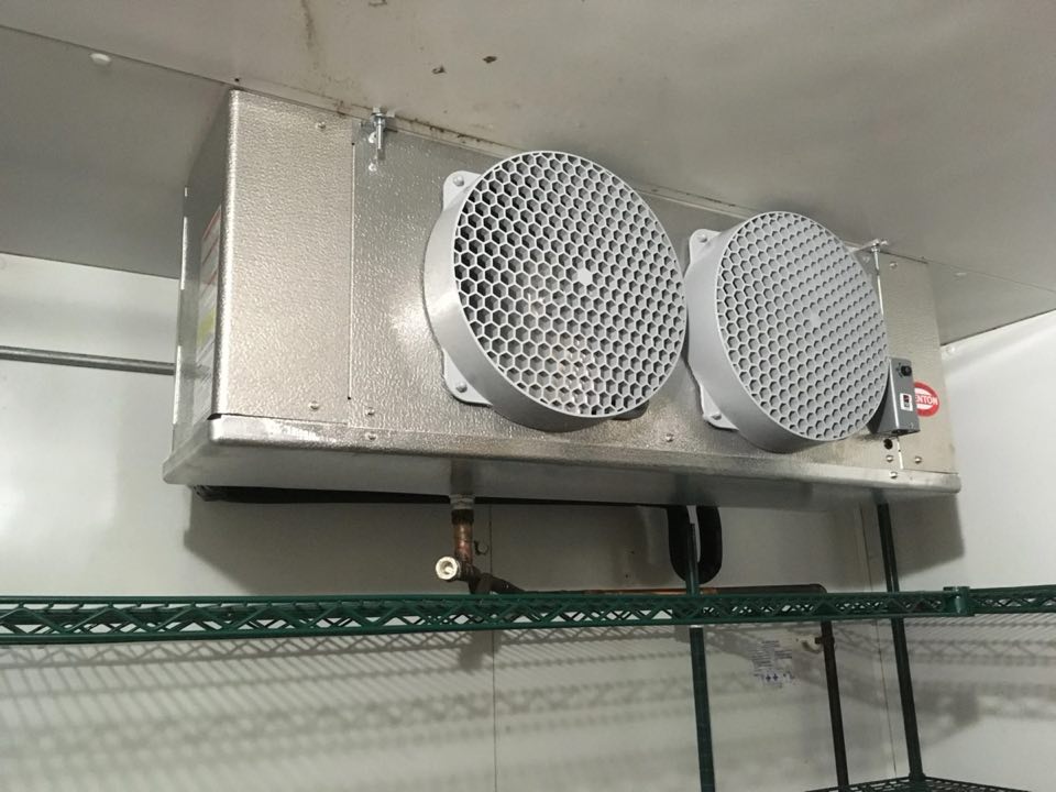 Evaporator coil mounted inside a walk-in cooler